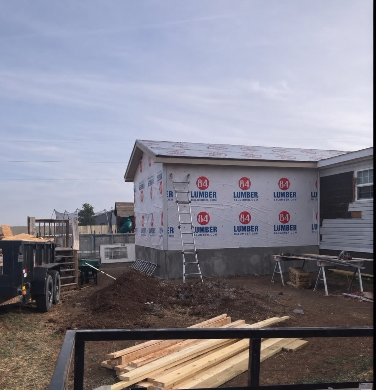 Home addition wrapped and roofing stage